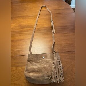 Anthropology tan suede Crossbody bag with adjustable straps.